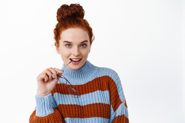 Close up of confident young woman look like professional, having her red hair combed in hairbun,...