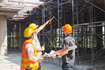 Three engineers working in a construction site