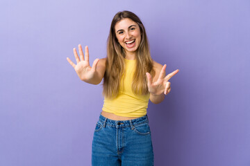 Young woman over isolated purple background counting eight with fingers