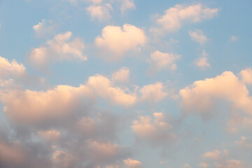 Scattered clouds of orangeyellow color and spring evening light Evening cloud background concept