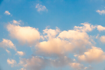 Scattered clouds of orangeyellow color and spring evening light Evening cloud background concept
