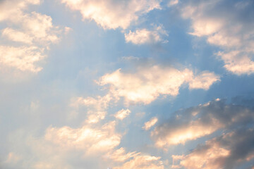 Scattered clouds of orangeyellow color and spring evening light Evening cloud background concept