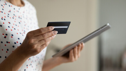 Electronic payment. Close up of female shopper hands hold digital tablet credit card make purchase...