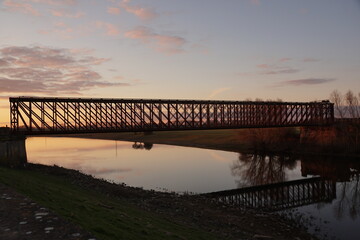 Naklejka premium Sunset at an old rail bridge