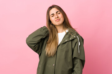 Young woman over isolated pink background with neckache