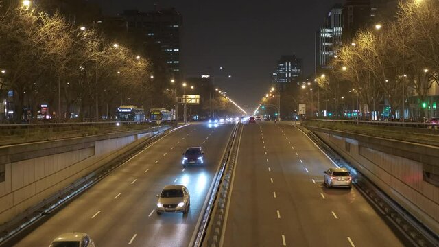Busy road of Paseo de la Castellana, illuminated Madrid city night street view. Europe, capital of Spain