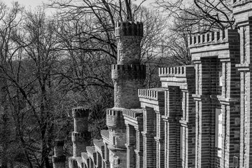 Vendée, France; February 26, 2021: black and white photo of the rosary its 16 stelae framed by crenellated brick turrets of La Salette, sacred buildings located in La Rabatelière.

