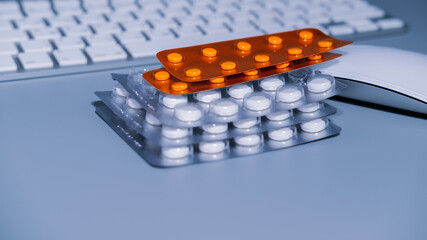 Keyboard with blistered medicine pills. Closeup, copy space. Work and health balance concept