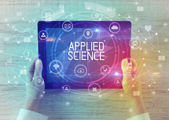 Close-up of a tablet with APPLIED SCIENCE inscription, innovative technology concept