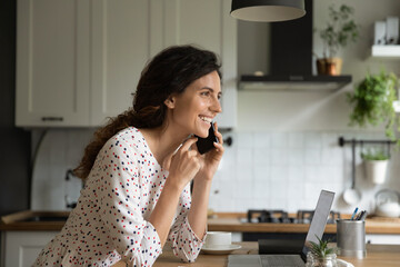 That is what I think. Smiling young lady working from home give remote phone consultation to client. Confident female expert speak by cell hold gadget at ear share good idea solution with colleague