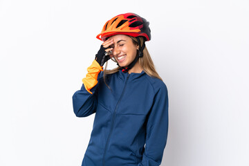 Young hispanic cyclist woman isolated on white background laughing