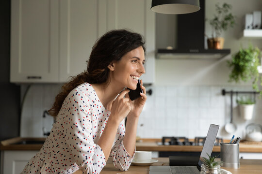 That is what I think. Smiling young lady working from home give remote phone consultation to client. Confident female expert speak by cell hold gadget at ear share good idea solution with colleague