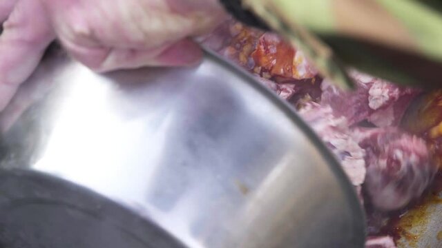 diced lard is fried in a pan mixed with a wooden spoon. Bograch.