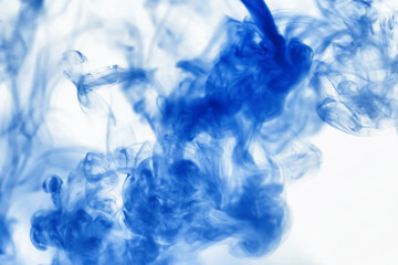 Puffs of paint in water. The dissolution of the dye in water. Water pollution. Concept art creativity.