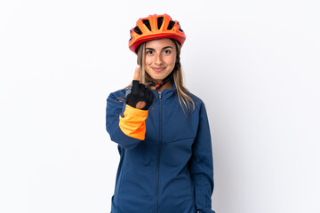 Young hispanic cyclist woman isolated on white background doing coming gesture
