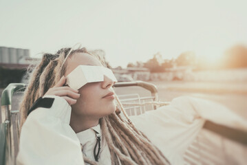 Young modern woman with chrome shades relaxing in shopping cart