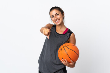 Young hispanic woman playing basketball over isolated white background pointing front with happy expression