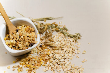 Healthy wholesome breakfast granola on beige background, selective focus, copy text