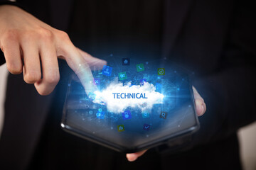 Businessman holding a foldable smartphone with TECHNICAL inscription, technology concept