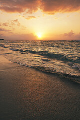 beautiful golden sunset on the beach over the sea with some dreamy clouds