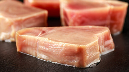 Raw Tuna Steaks ready to cook on Dark Gray Background with Copy Space