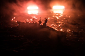 Silhouettes of a crowd standing at blurred military war ship on foggy background. Selective focus....