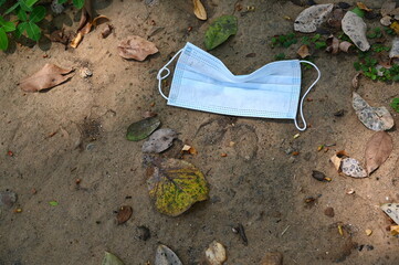 The mask was improperly dropped to the ground.The correct way to dispose of the protective mask is...