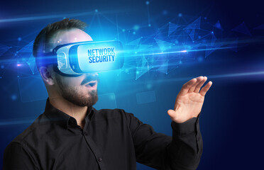 Businessman looking through Virtual Reality glasses with NETWORK SECURITY inscription, cyber security concept