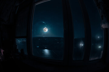 Full moon over the valley in window view. Fisheye lens shot wind angle