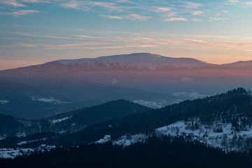 A view of the Babia Gora massif with the Diablak peak during the winter sunset. Stryszawa village ...
