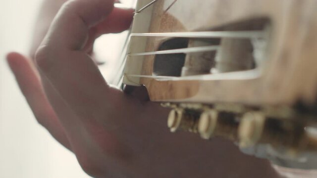 man plays the classical guitar close-up. musician's rehearsal