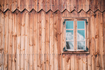 Fototapeta na wymiar Wooden windows on the old wooden wall of the mill