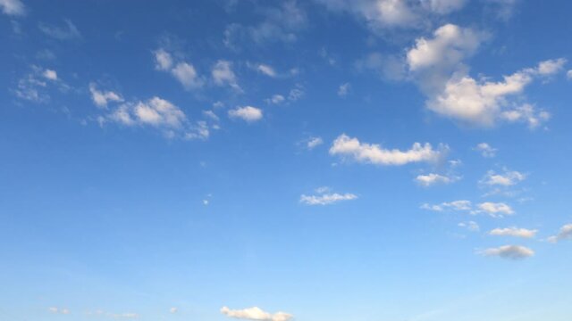 Slow Motion 4k cinemagraph b-roll TimeLapse, Beautiful sunny clear blue sky background with puffy fluffy white cloud n cumulus cloudscape in tropical summer n spring sunlight n sun ray at sunshine day