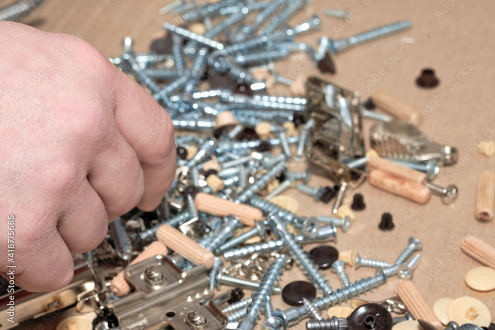 Wall mural the hand of the master against the background of the crumbled fastener