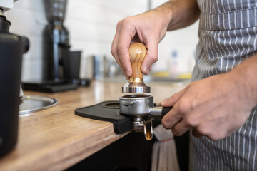 Male hands holding coffee machine filter holder