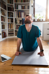 man  doing yoga at home