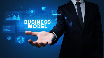 Hand of Businessman holding BUSINESS MODEL inscription, business success concept