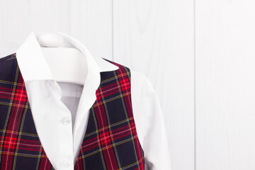 School uniform for a boy hangs on a hanger