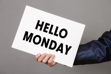 Businessman holds it in your hand card with Hello Monday text