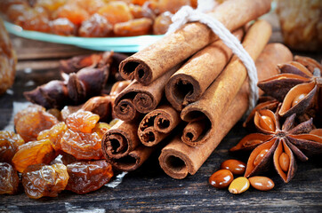 Spices cinnamon, anise stars, raisins up close, on a wooden background.Selective focus.