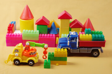 Construction transport and transportation in the city. Toy cars on the background of a toy city. 