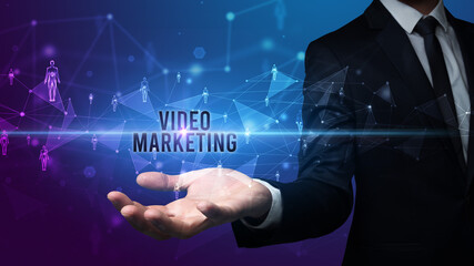 Elegant hand holding VIDEO MARKETING inscription, social networking concept