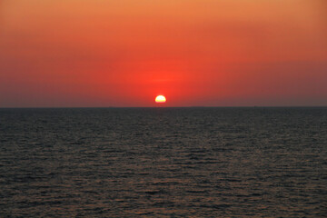 Nature shot of the sea blurred and the sun blurred