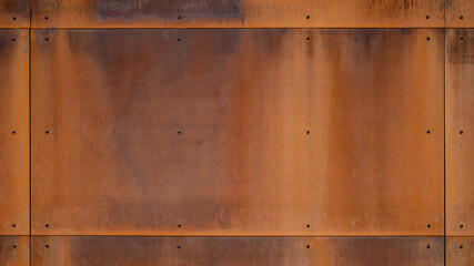 Grunge rusty corten steel facade wall with rivets, rust metal texture background