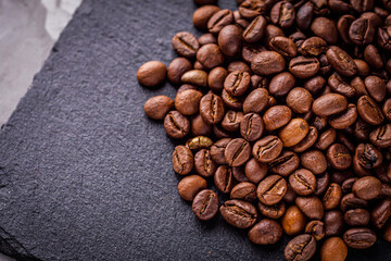 aromatic fresh coffee beans on a dark stone background