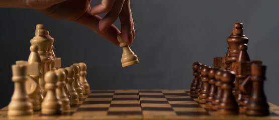 Hand moving white pawn and making first step