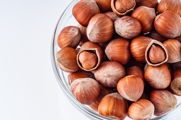 fresh natural hazelnuts on a white acrylic background