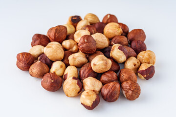 fresh natural hazelnuts on a white acrylic background