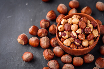 fresh natural hazelnuts on a dark stone background
