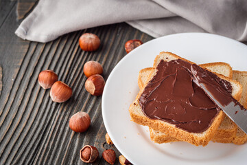 toasts with chocolate butter on a dark wooden rustic background